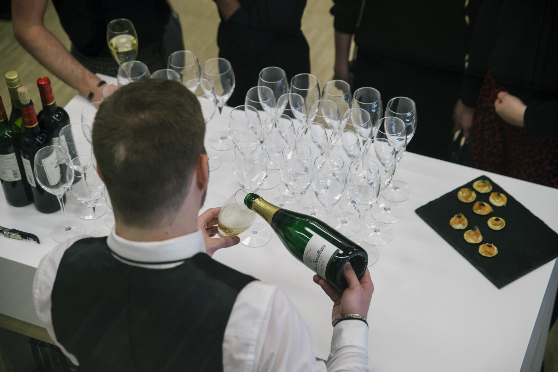 waiter pouring champagne in a glass