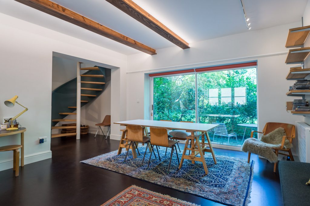 decorated living room with a visible staircase on the left, london house